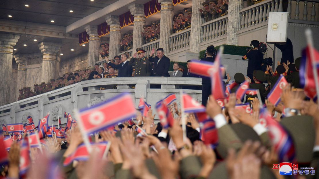 North Korean leader Kim Jong Un, Chinese Communist Party Politburo member Li Hongzhong and Russia's Defense Minister Sergei Shoigu greet people as they attend a military parade in Pyongyang.