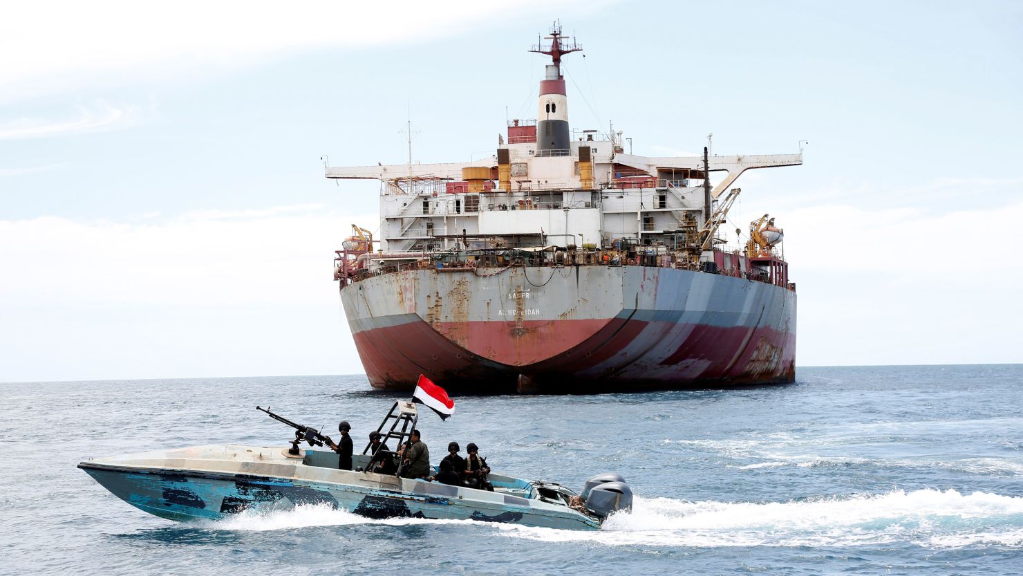 A Yemeni coast guard boat sails past the FSO Safer vessel at Ras Issa port in Hodeidah province, Yemen, on May 30.