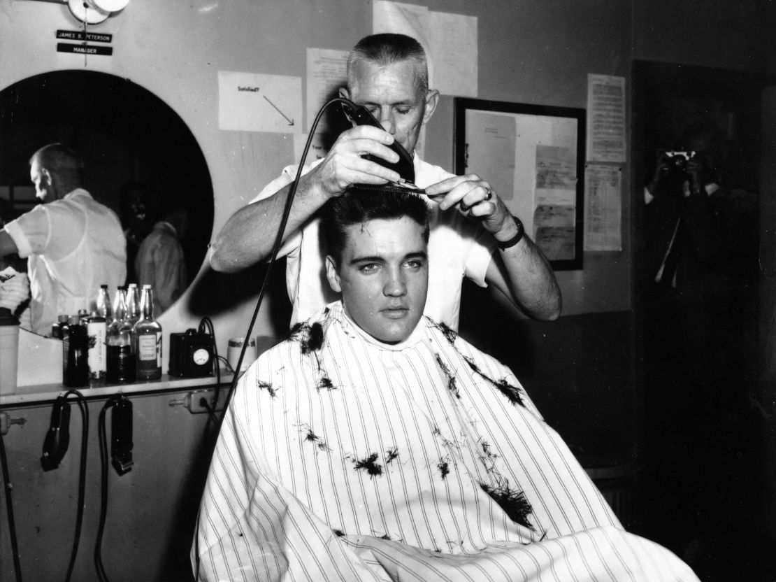 1959:  Rock and roll musician Elvis Presley gets his hair shorn off in preparation for his tour of duty in in the United States Army in 1959 in Germany. (Photo by Michael Ochs Archives/Getty Images