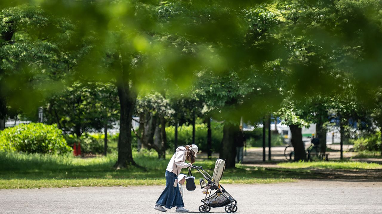 A woman walks with her child at a park in Tokyo, Japan, on May 11, 2023. 