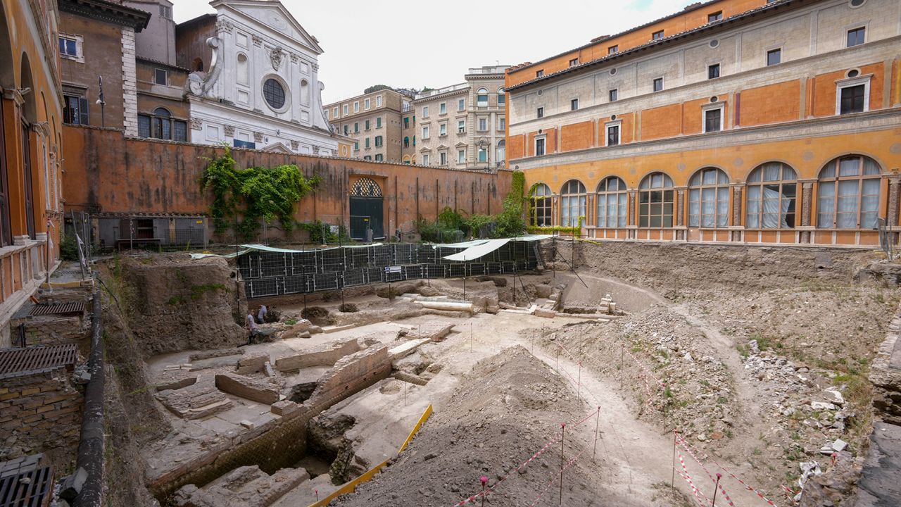 People walk in the excavation site of the ancient Roman emperor Nero's theater.