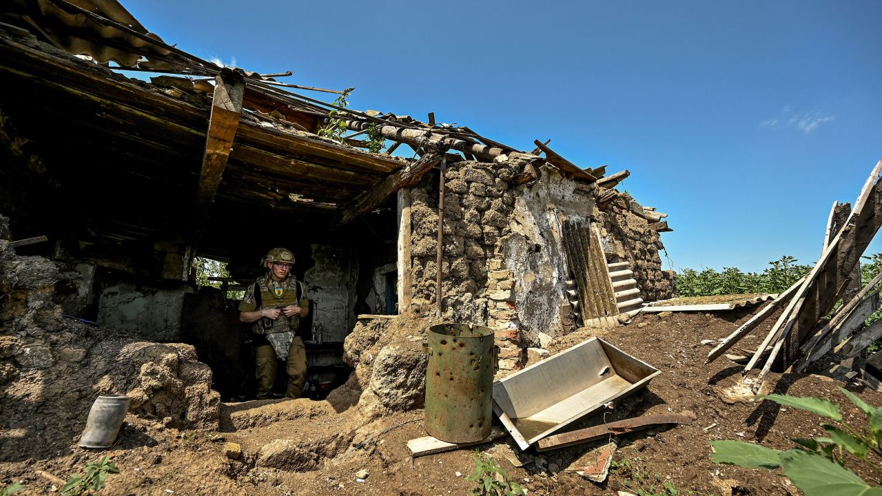 A Ukrainian serviceman inspects a former position of Russian troops.