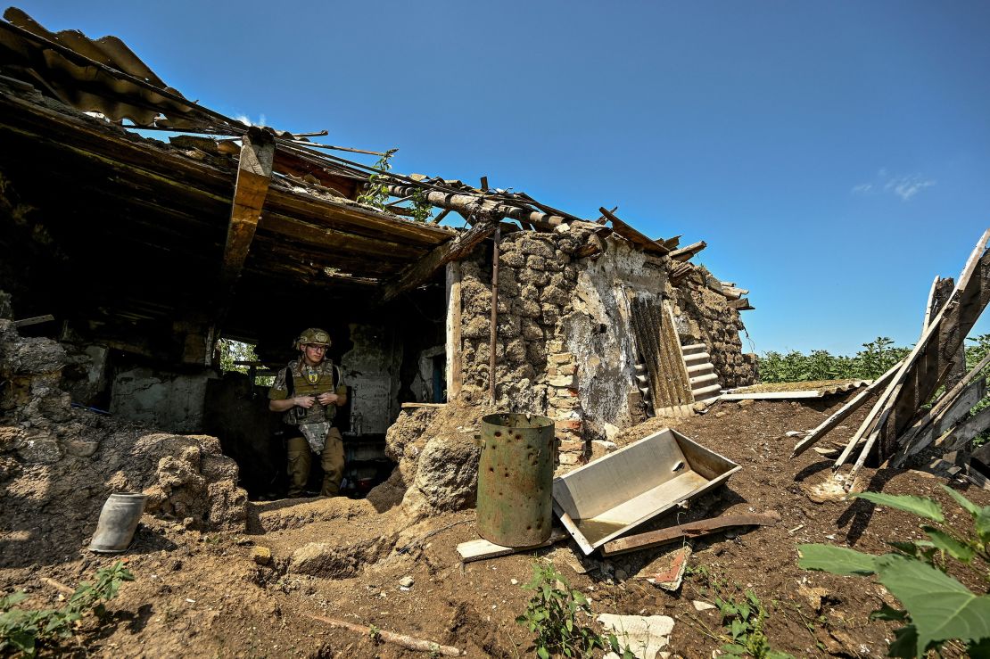 A Ukrainian serviceman inspects a former position of Russian troops.