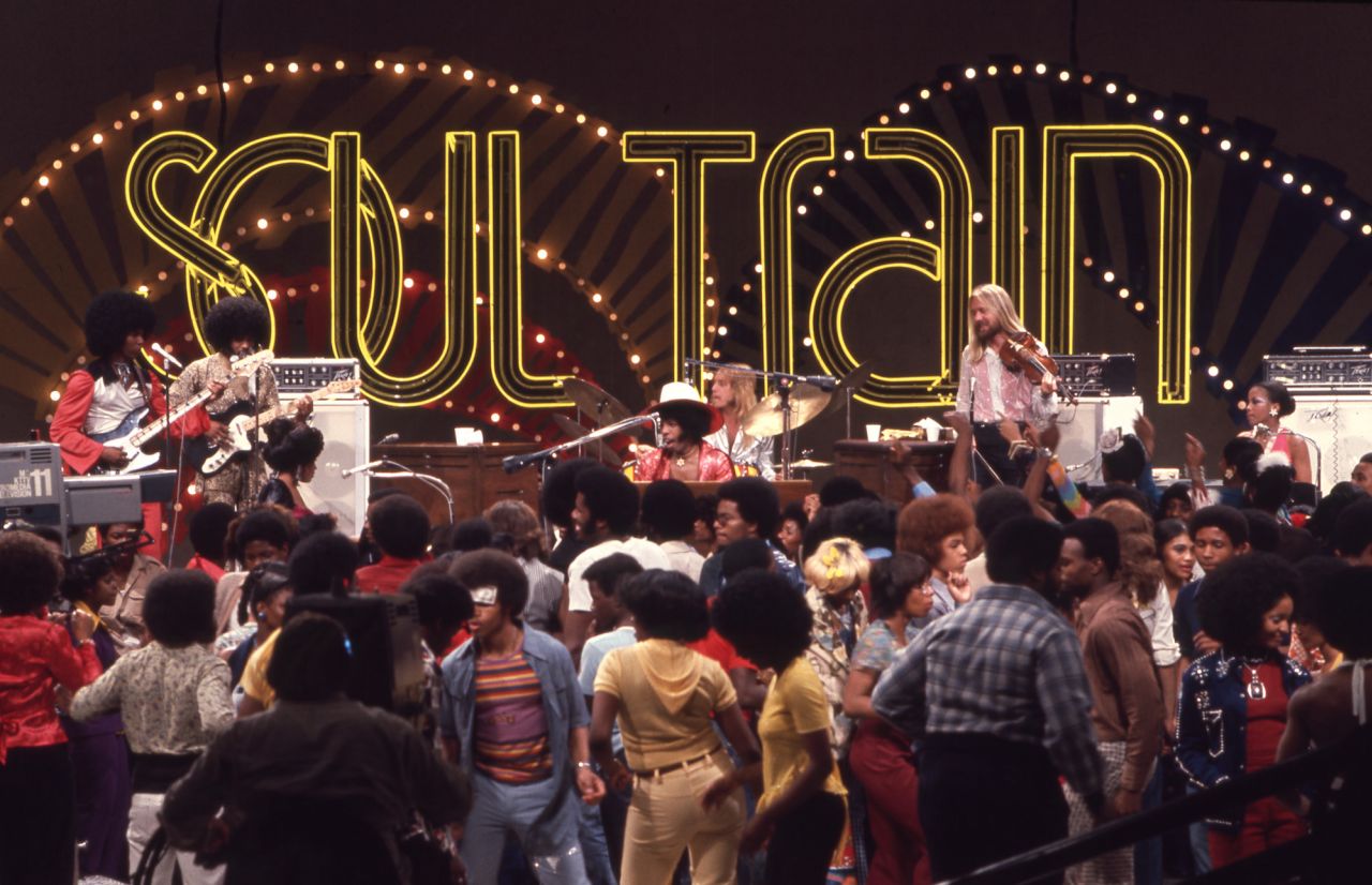 Sly and the Family Stone perform on Soul Train Episode 105, aired 06/29/1974 in a wide shot that shows the entire Soul Train stage, cameramen and dance floor (Photo by Soul Train via Getty Pictures).
