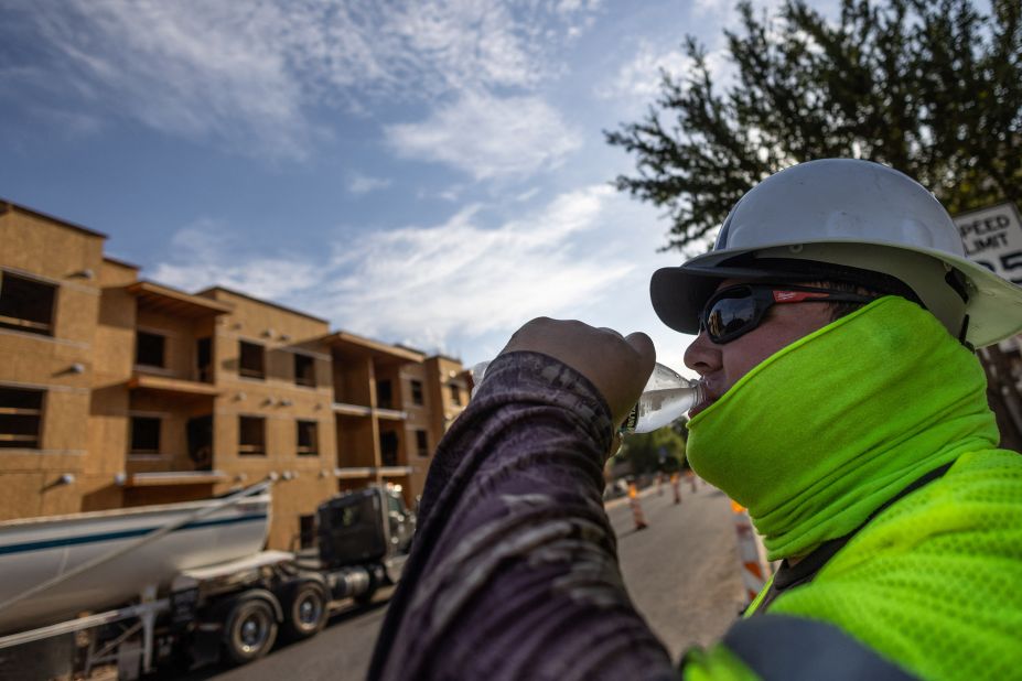 A construction worker drinks cold water during a heat wave where temperatures have reached over 110 degrees Fahrenheit for 27 consecutive days in Scottsdale, Arizona, on July 28.