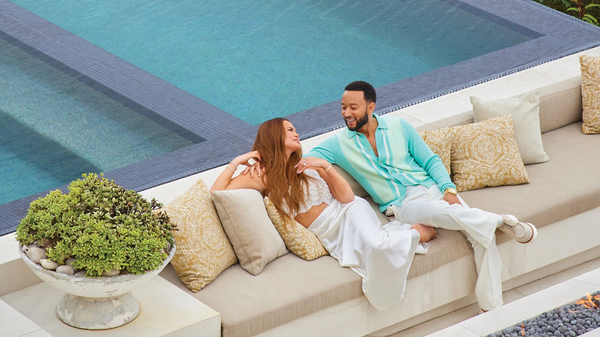Chrissy Teigen and John Legend poolside at their new Beverly Hills property.