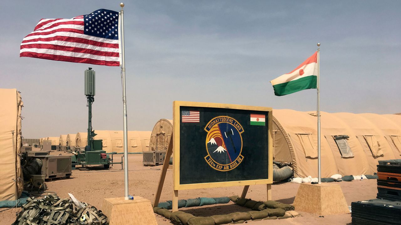 In this April 2018 file photo, US and Niger flags are raised side by side at the base camp for air forces and other personnel supporting the construction of Niger Air Base 201 in Agadez, Niger. 