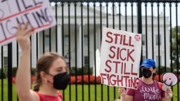 Protestors march outside the White House to call attention to those suffering from long COVID-19.