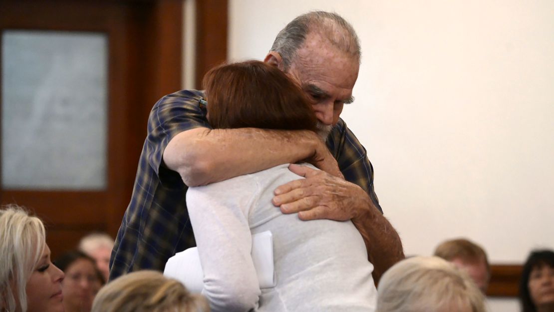 Kay and Larry Woodcock, the grandparents of JJ Vallow, embrace after Kay Woodcock's statement Monday.