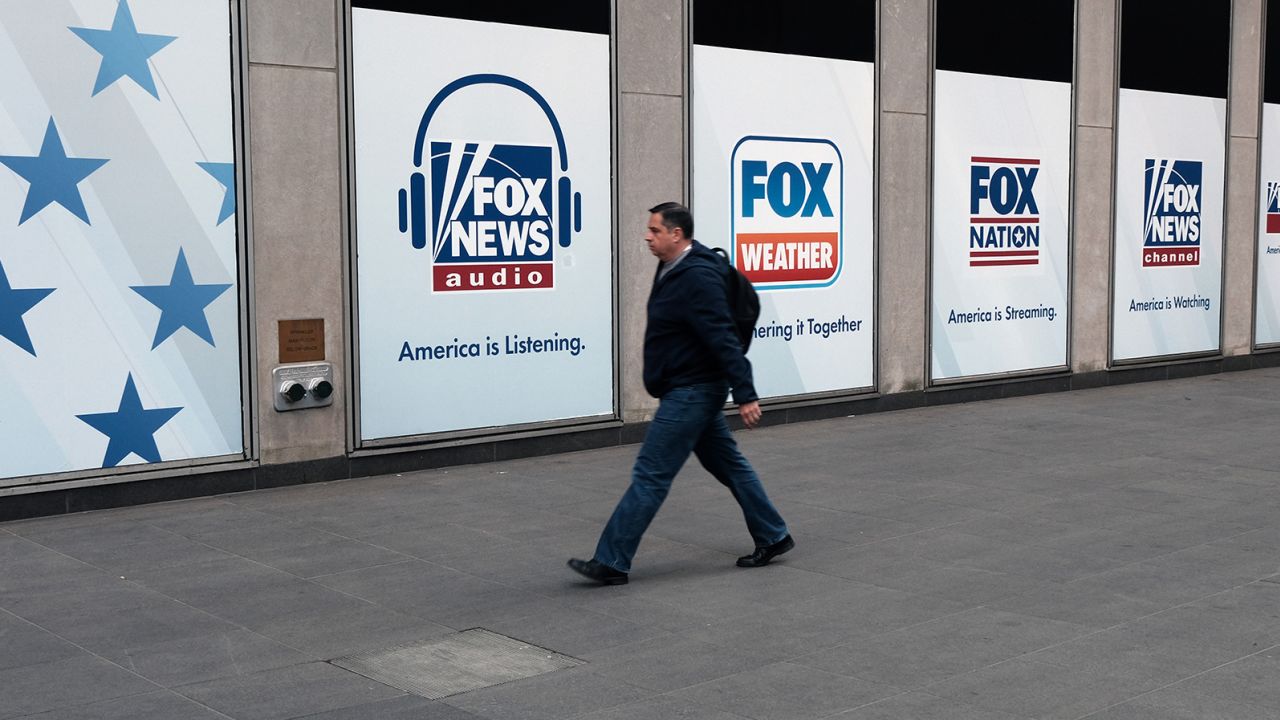 People walk by the News Corporation headquarters, home to Fox News, on April 18, 2023 in New York City. 