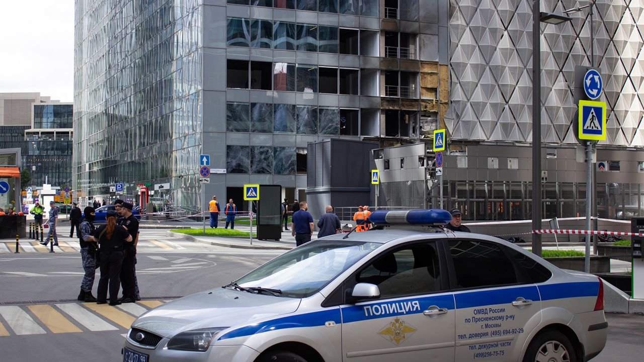 Police car seen near a damaged building at the sight of another drone attack in Moscow on July 30, 2023.