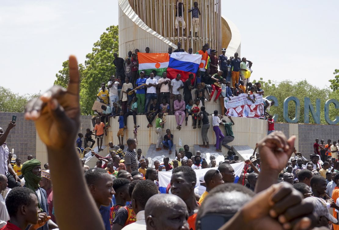 Anti-colonial and pro-Russia supporters stand outside the National Assembly building in Niamey on Sunday.