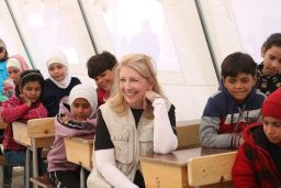 On 1 March 2023 in in Aleppo, Syria, UNICEF Executive Director Catherine Russell sits with children while visiting Ahmad Adeeb Al-Ali School ("The School Shelter"), which is currently operating as a temporary collective shelter for children and families affected by the recent devastating earthquakes.
