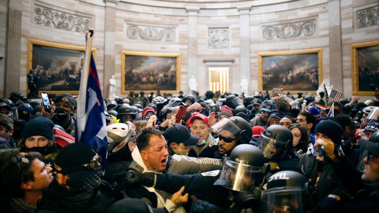 Police clash with pro-Trump rioters who had entered the Capitol. 