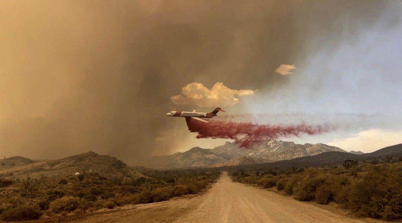 A tanker drops fire retardant over the York Fire in the Mojave National Preserve on Saturday.