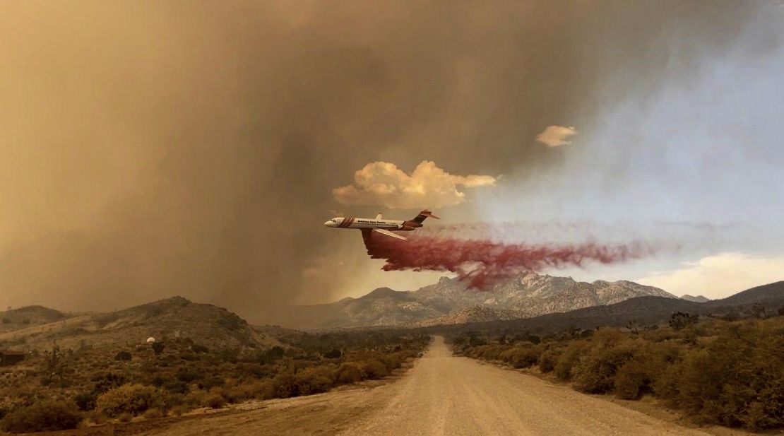 A tanker makes a fire retardant drop over the York Fire in Mojave National Preserve on Saturday.