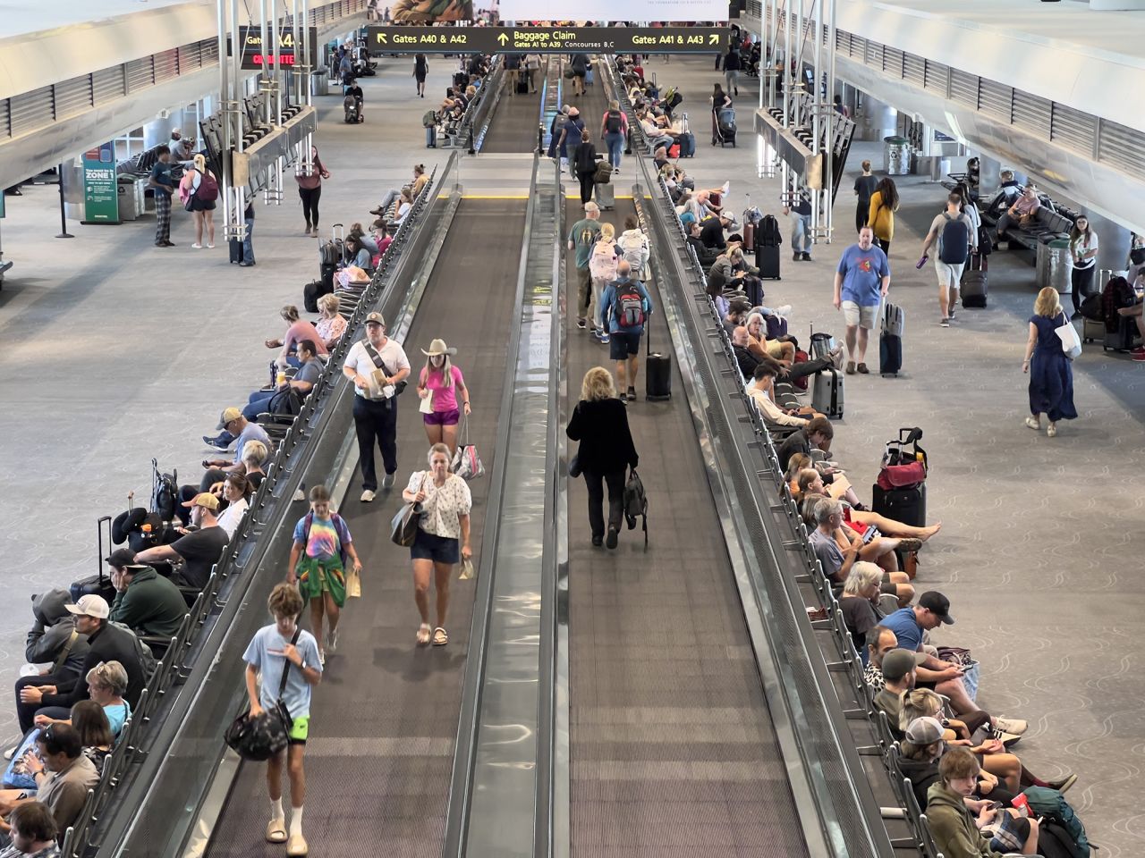 Travellers walk through Denver International Airport (DEN) in Denver, Colorado, on July 30, 2023. 