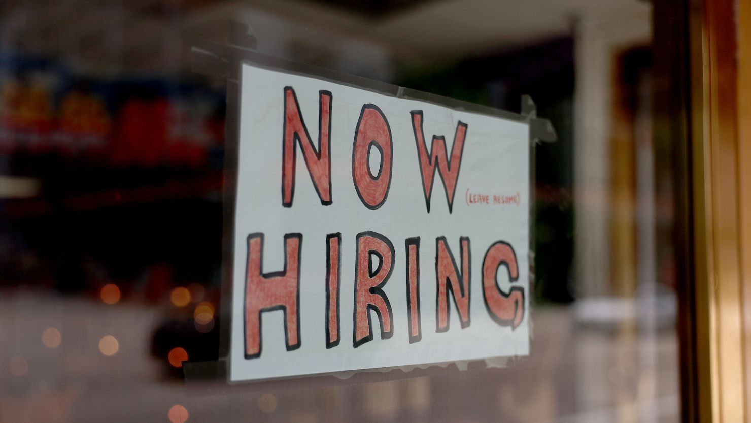 MIAMI, FLORIDA - MAY 05: A 'Now Hiring' sign posted on the window of a business looking to hire workers on May 05, 2023 in Miami, Florida. A report by the Bureau of Labor Statistics showed the US economy added 253,000 jobs in April.  (Photo by Joe Raedle/Getty Images)