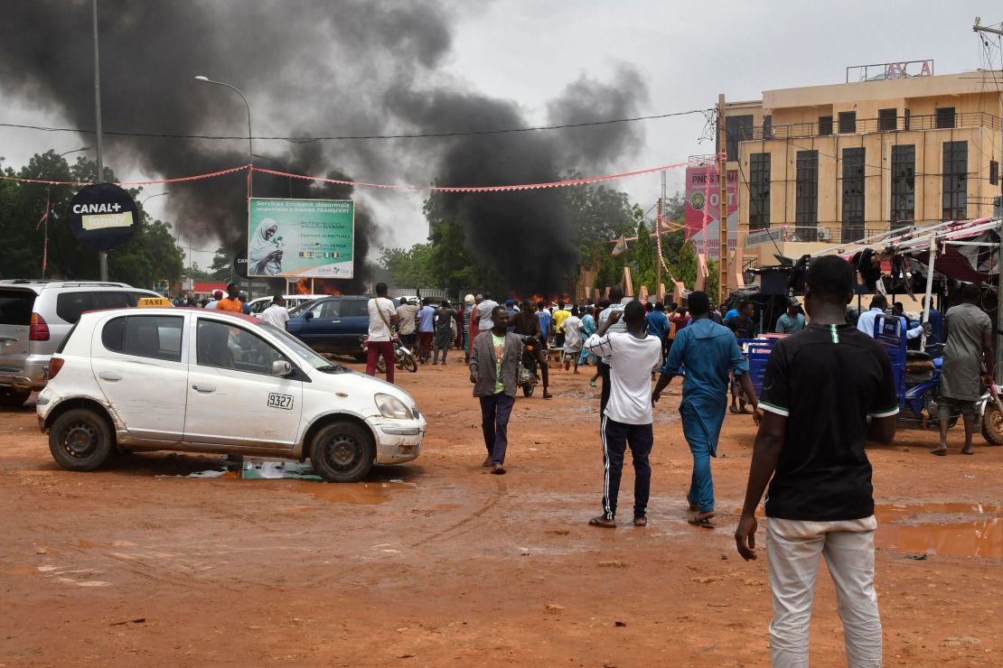 Smoke billows as supporters of the Nigerien defence and security forces attack the headquarters of the Nigerien Party for Democracy and Socialism (PNDS), the party of overthrown President Mohamed Bazoum, in Niamey on July 27, 2023.