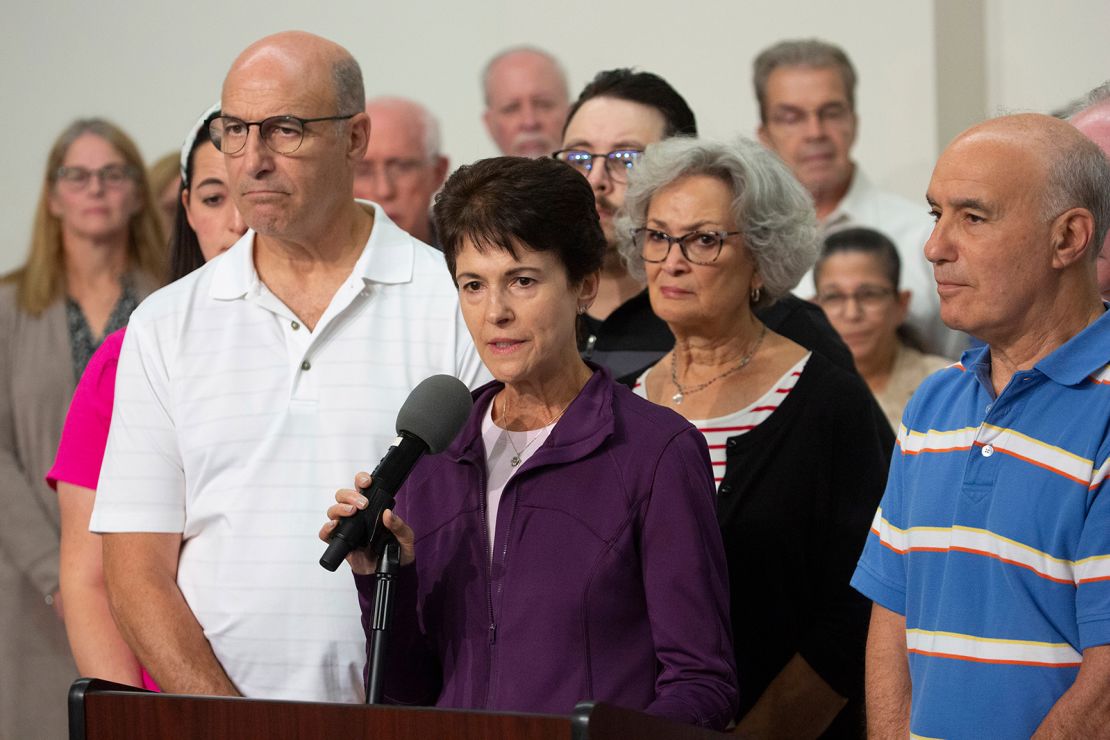 Shooting survivor Andrea Wedner, center, spoke to the media surrounded by family members, victims and families on Wednesday.