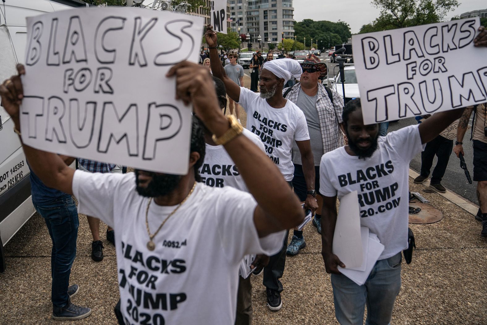 Trump supporters hold "Blacks For Trump" signs outside the federal court in Washington, DC, on Thursday.