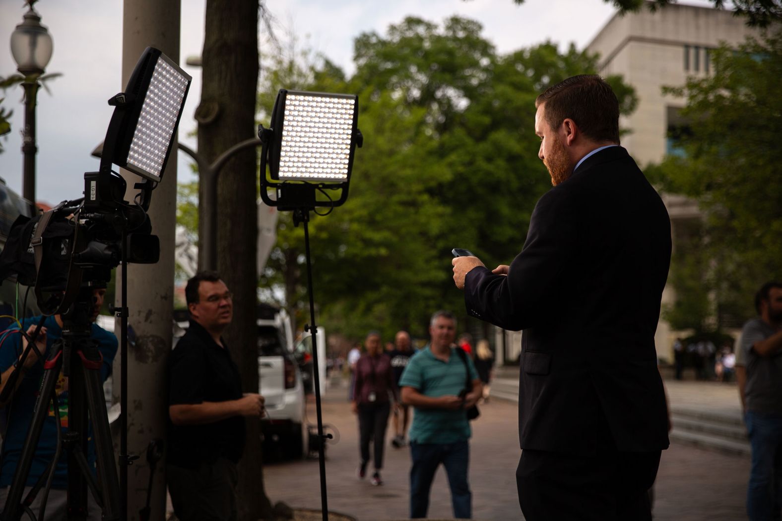 A reporter with ABC7 prepares for a standup outside the courthouse on Thursday.