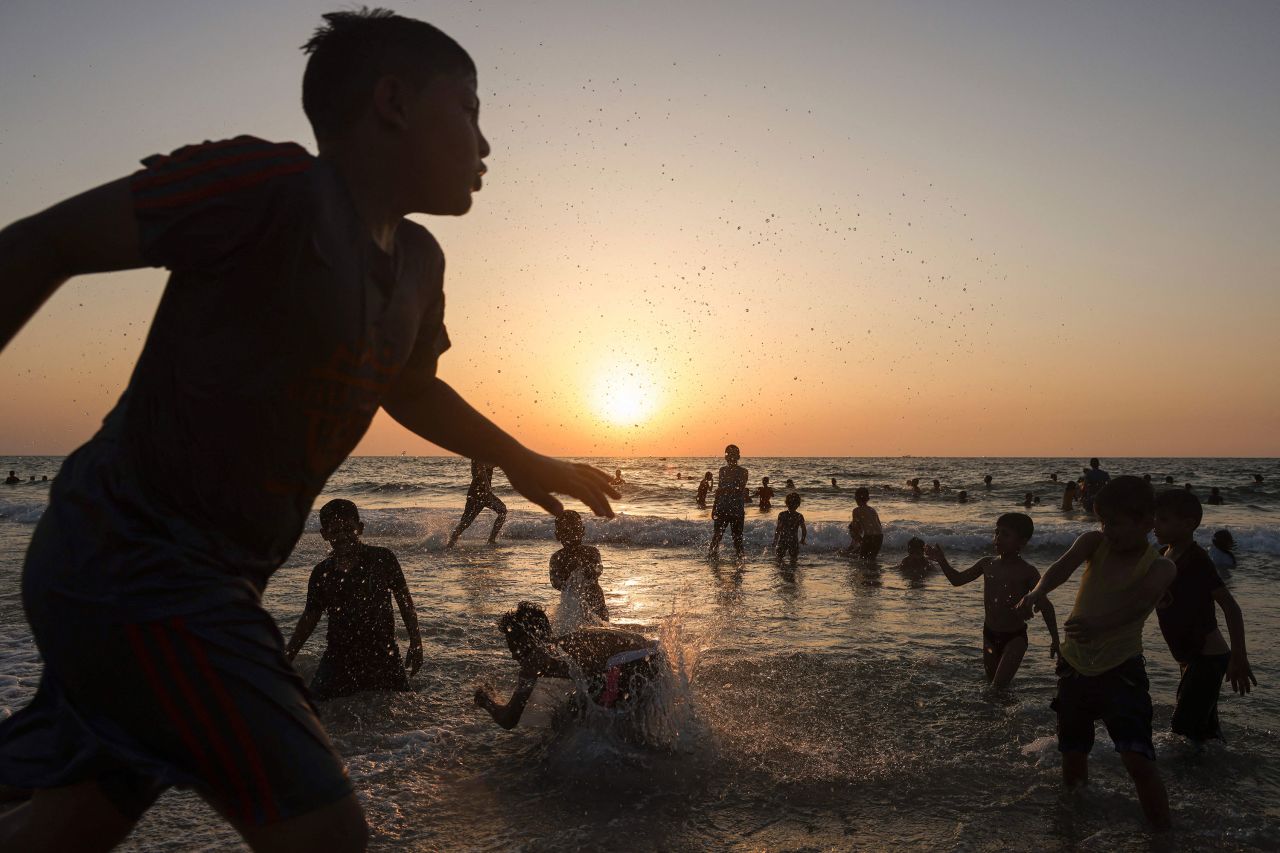 Children play in the water at the beach in Gaza City on Thursday, July 27.