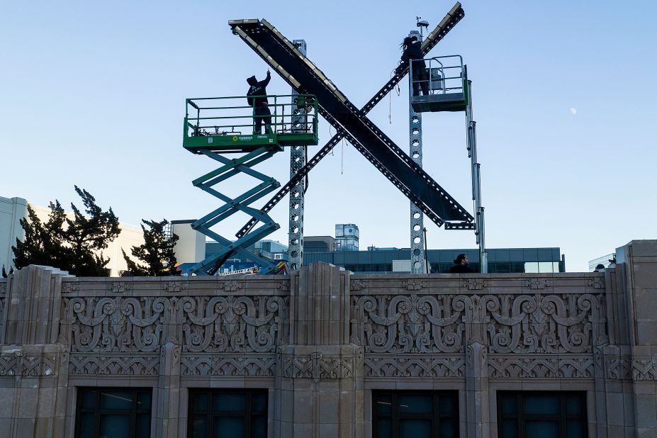 Workers install lighting on an 