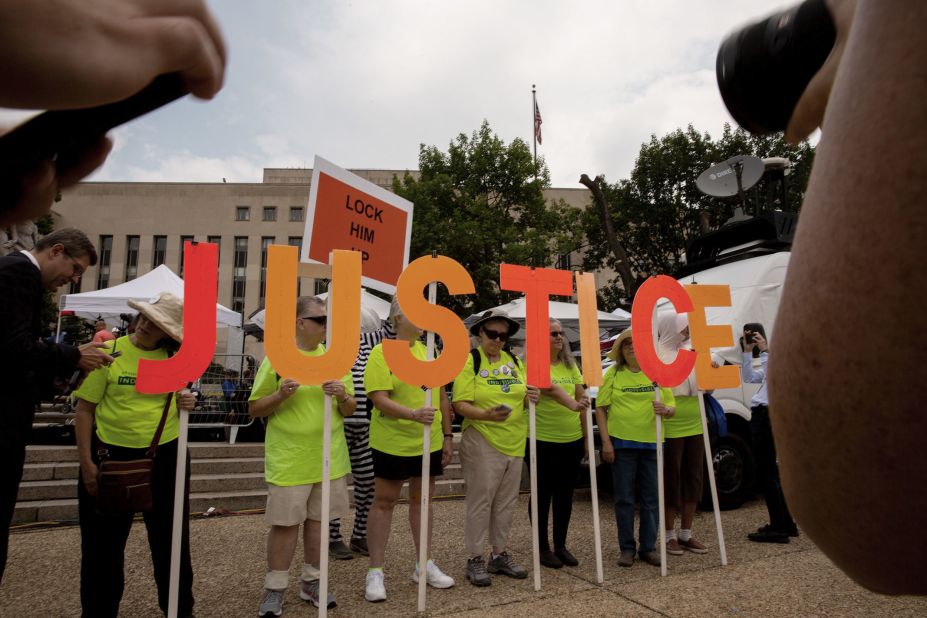 People with the progressive organization Herndon Reston Indivisible demonstrate outside the federal courthouse in Washington, DC, before <a href=