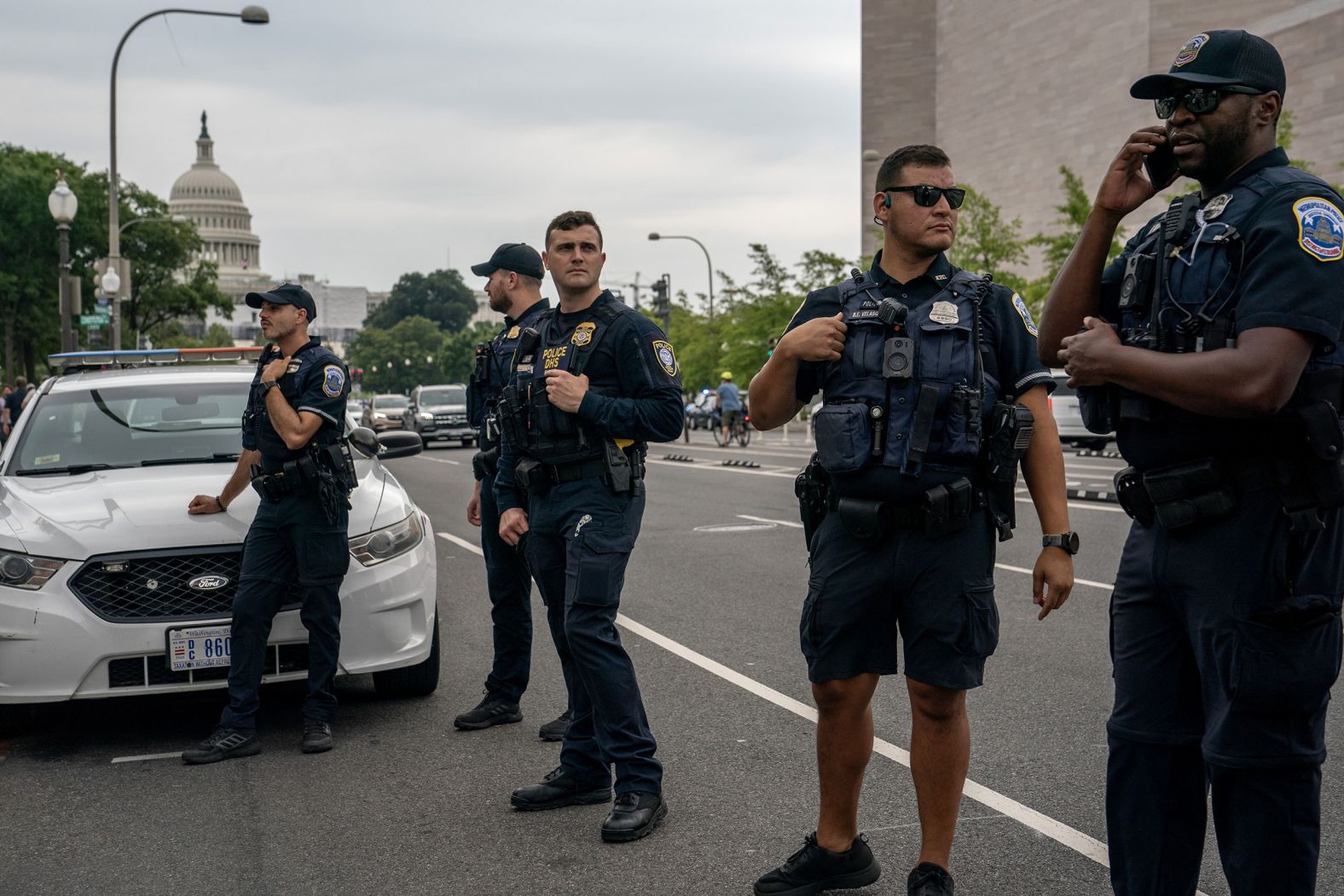 Law enforcement officers patrol outside the courthouse.