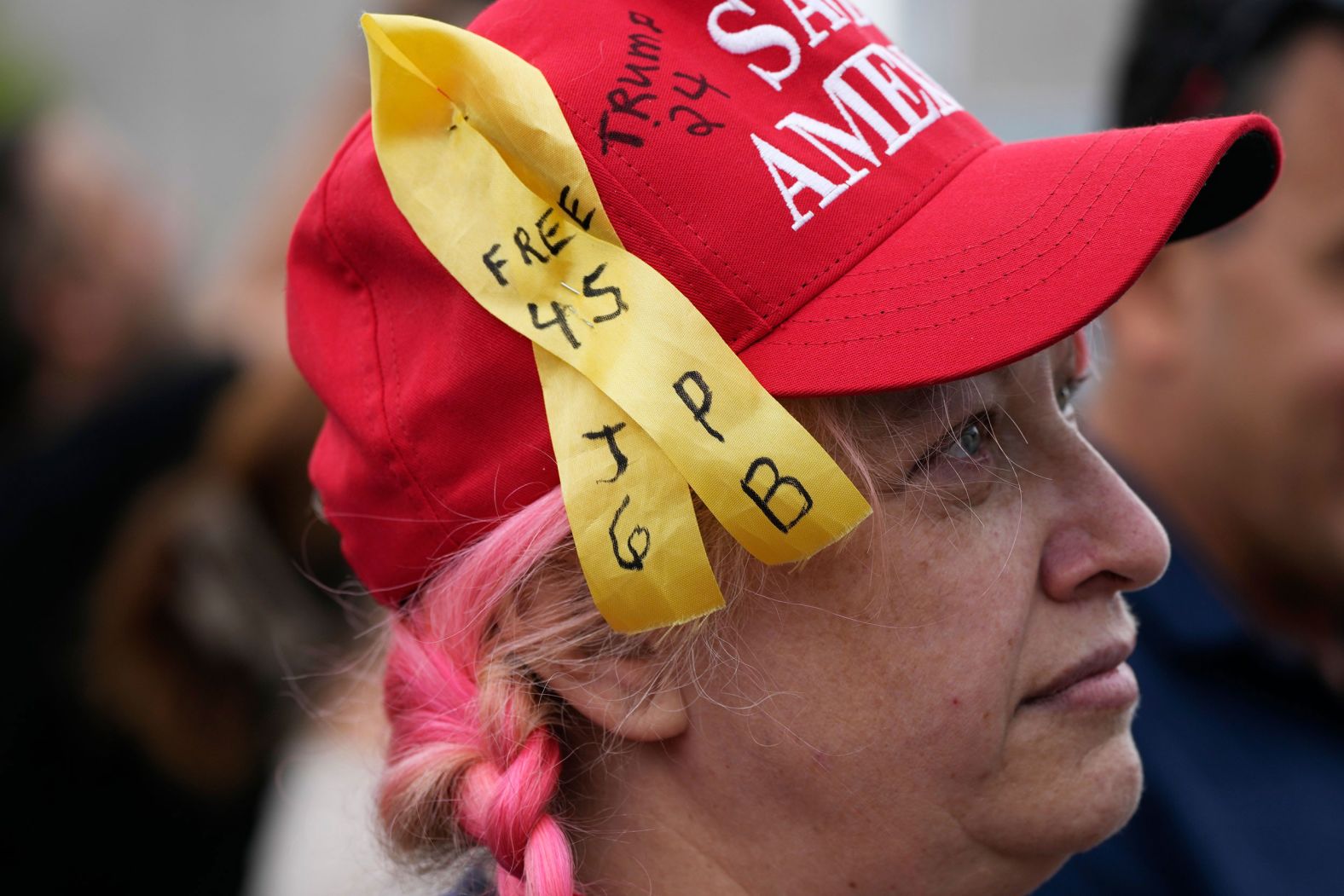 Suzzanne Monk wears a ribbon in support of the people who were arrested after participating in <a href="index.php?page=&url=https%3A%2F%2Fwww.cnn.com%2F2022%2F01%2F03%2Fpolitics%2Fgallery%2Fjanuary-6-capitol-insurrection%2Findex.htmlhttps%3A%2F%2Fwww.cnn.com%2F2022%2F01%2F03%2Fpolitics%2Fgallery%2Fjanuary-6-capitol-insurrection%2Findex.html" target="_blank">the January 6 Capitol riot</a>.