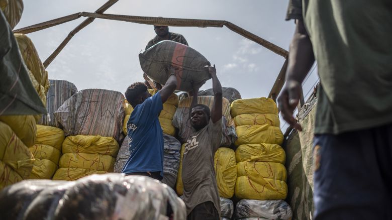 Workers unload a delivery of second-hand garments at the Kantamanto textile market in Accra, Ghana, on Thursday, Sept. 15, 2022. The rise of fast fashion—and shoppers' preference for quantity over quality—has led to a glut of low-value clothing that inordinately burdens developing countries. Photographer: Andrew Caballero-Reynolds/Bloomberg