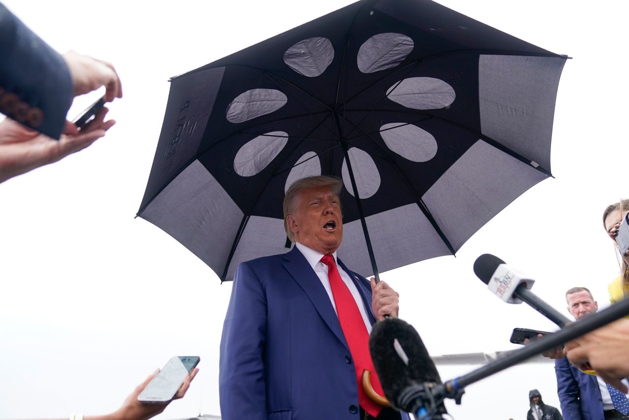 Former President Donald Trump speaks to reporters before he boards his plane at Ronald Reagan Washington National Airport after his arraignment in federal court on Thursday, August 3.
