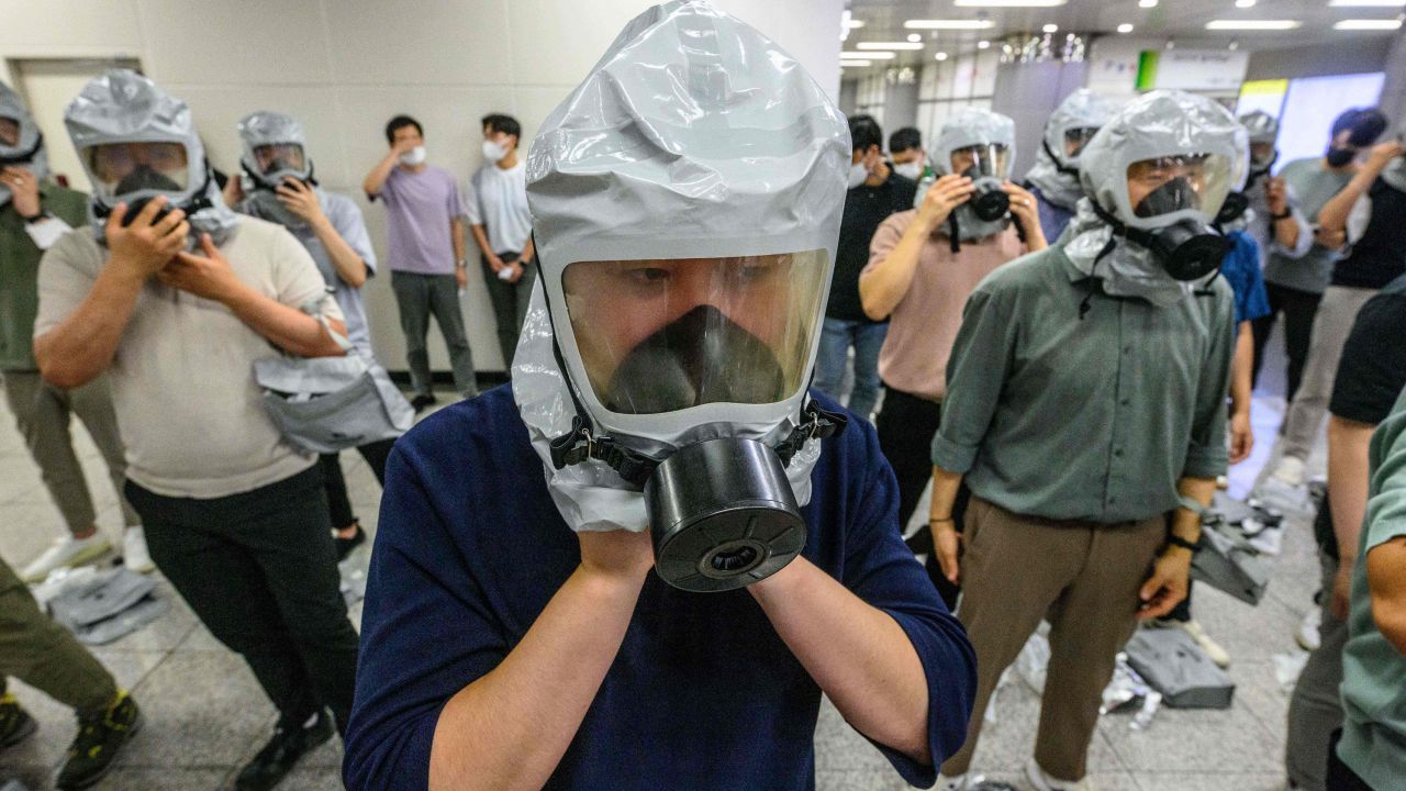 Civilians put on gas masks as they participate in an anti-terror and anti-chemical drill on the sidelines of the joint South Korea-US Ulchi Freedom Shield (UFS) military exercises, at a metro station in Incheon, west of Seoul, on August 24, 2022. (Photo by Anthony WALLACE / AFP) (Photo by ANTHONY WALLACE/AFP via Getty Images)