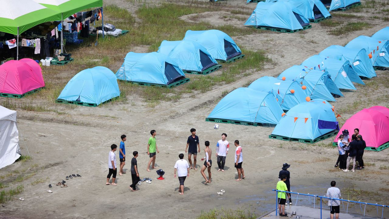 Participants play with a ball at the camping site for the 25th World Scout Jamboree in South Korea on August 4, 2023.
