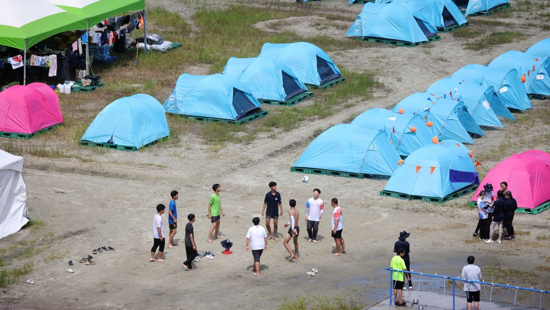 Participants play with a ball at the campsite for the 25th World Scout Jamboree in South Korea, on August 4, 2023.