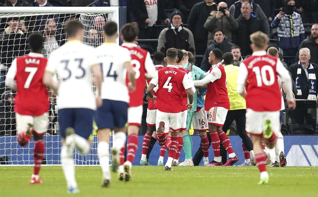 Arsenal goalkeeper Aaron Ramsdale (centre) is held back by team-mates after a fan attempts to hit the player after the final whistle in the Premier League match at the Tottenham Hotspur Stadium, London. Picture date: Sunday January 15, 2023. (Press Association via AP Images)
