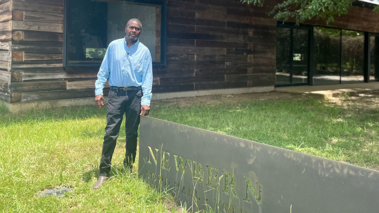 Patrick Braxton stands by the Newbern Town Hall, a building he says he's been locked out of. 