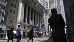 People walk past the New York Stock Exchange (NYSE) on Wall Street on August 1, 2023 in New York City.