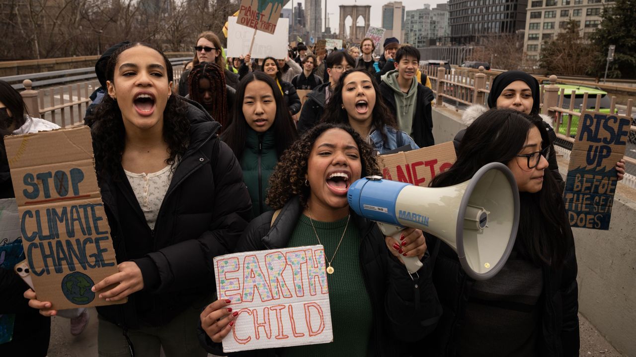 Demonstrators march across the Brooklyn Bridge during a Global Climate Strike in New York, US, on Friday, March 3, 2023. The theme of the strike is "End Fossil Finance." Photographer: Yuki Iwamura/Bloomberg via Getty Images