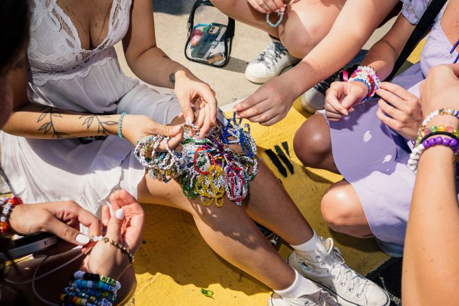 Fans in East Rutherford trade friendship bracelets in the parking lot of MetLife Stadium in May 2023.