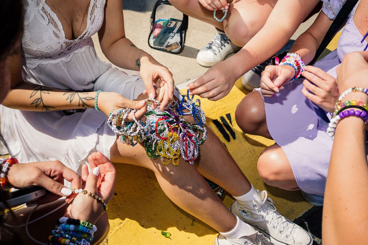 Fans in East Rutherford trade friendship bracelets in the parking lot of MetLife Stadium on May 26.