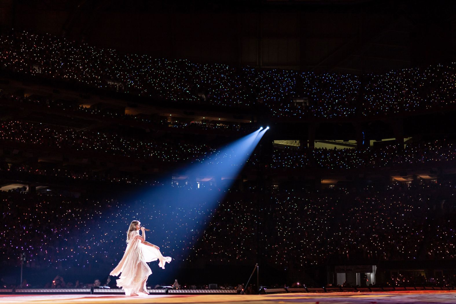 Swift dances across the stage while singing "August" in Atlanta in April 2023.