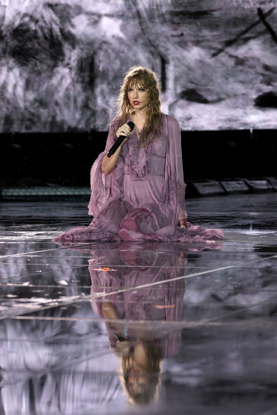 Swift performs the "Folklore" set in the rain in Nashville in May 2023. The show was delayed several hours due to storms in the area.