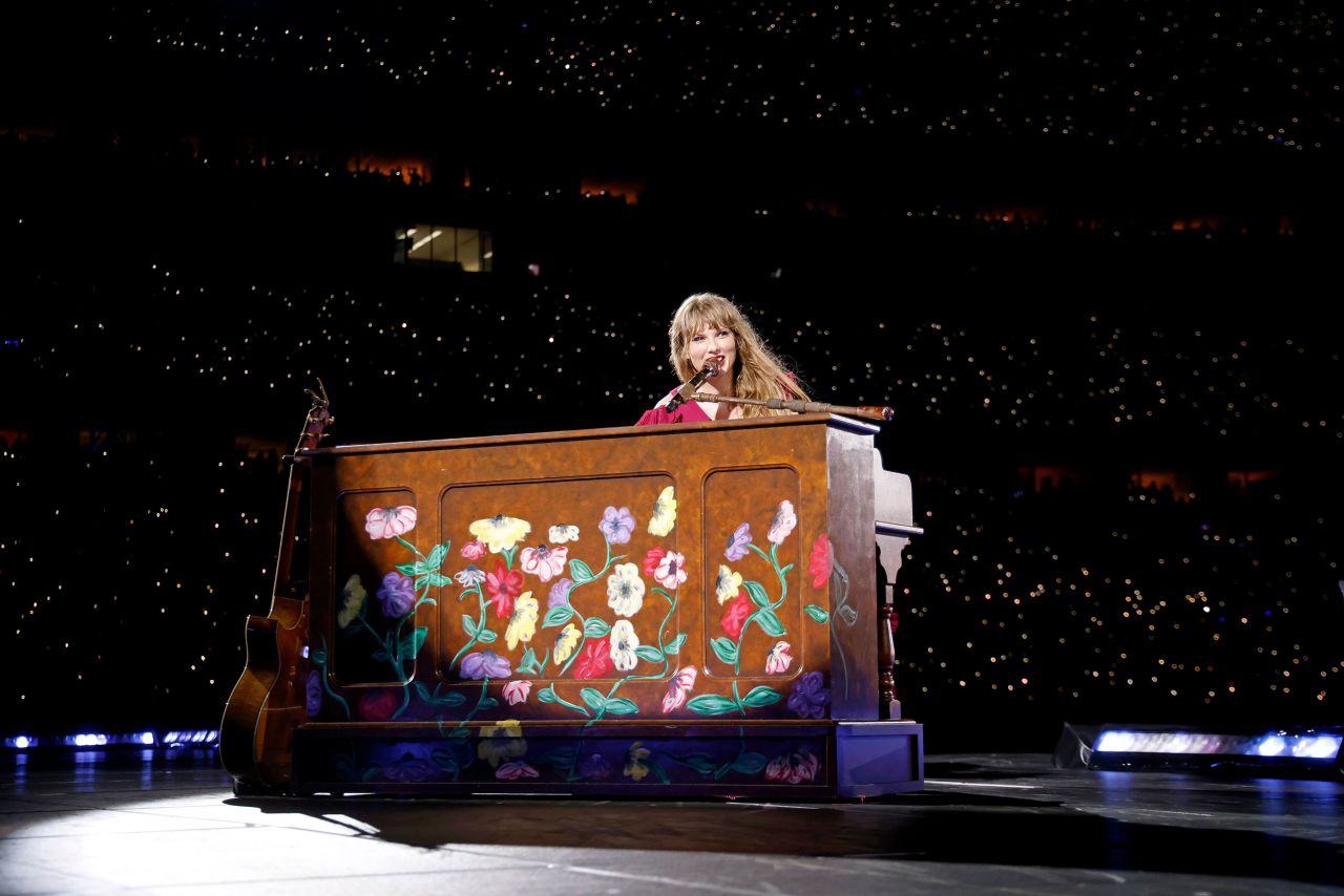 Swift performs "Evermore" in Cincinnati on June 30. Each night, Swift chooses two surprise songs from her discography to play acoustically — one on guitar and one on piano.