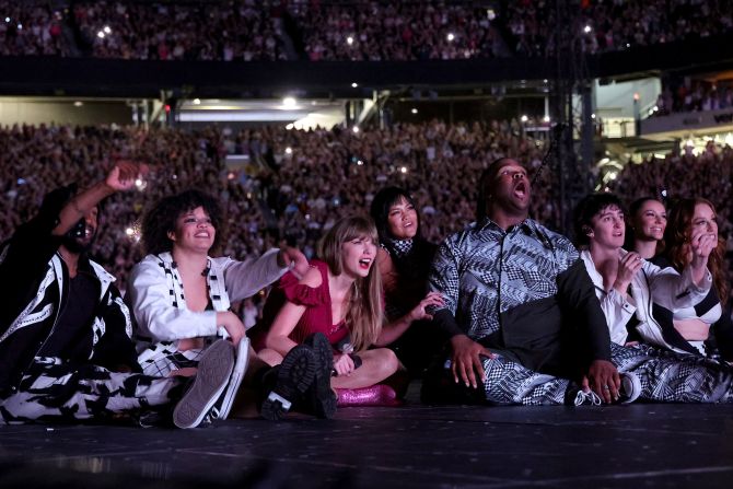 Swift and her backup dancers watch the premiere of the "Karma" music video while in East Rutherford in May 2023.