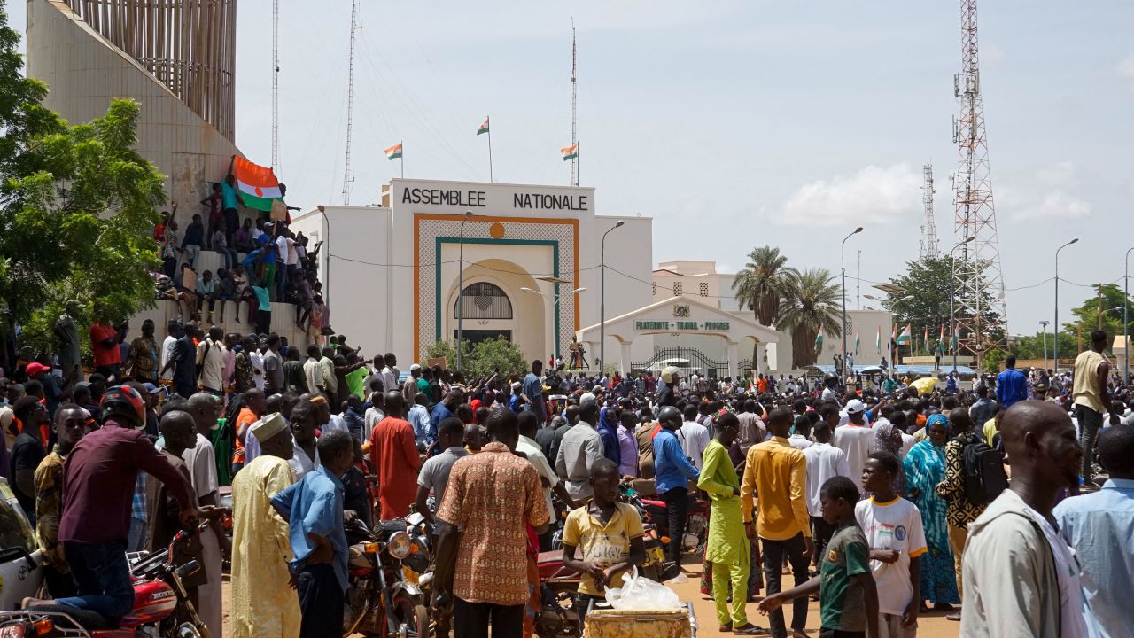People gather outside the National Assembly building during a protest in Niamey, Niger, on July 30. 