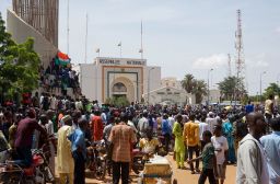 People gather outside the National Assembly building during a protest in Niamey, Niger, on July 30. 