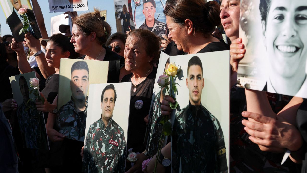 Relatives hold the pictures of some of those killed in the August 2020 Beirut port blast during a march marking the three-year anniversary of the disaster.