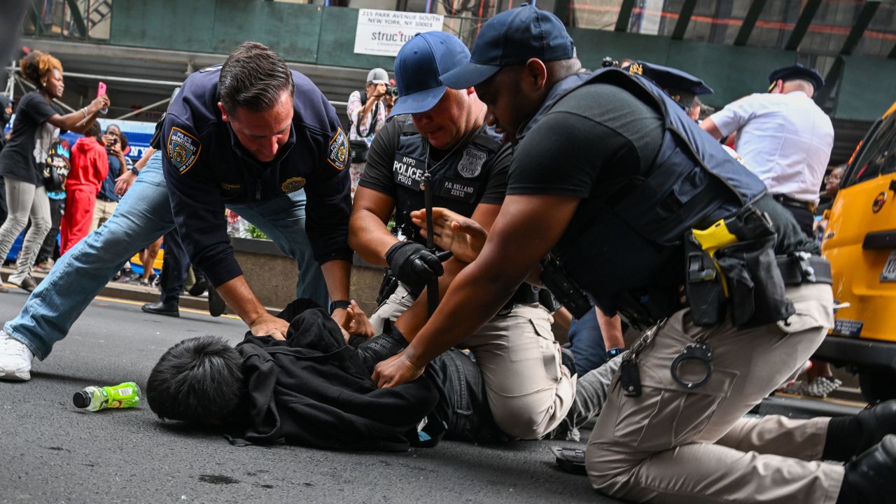 Members of the NYPD arrest people after responding to thousands of people gathered for a "giveaway" event announced by popular Twitch live streamer Kai Cenat in Union Square and the surrounding area on August 4, 2023 in New York City.